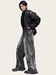 Person wearing a black jacket and gray pants