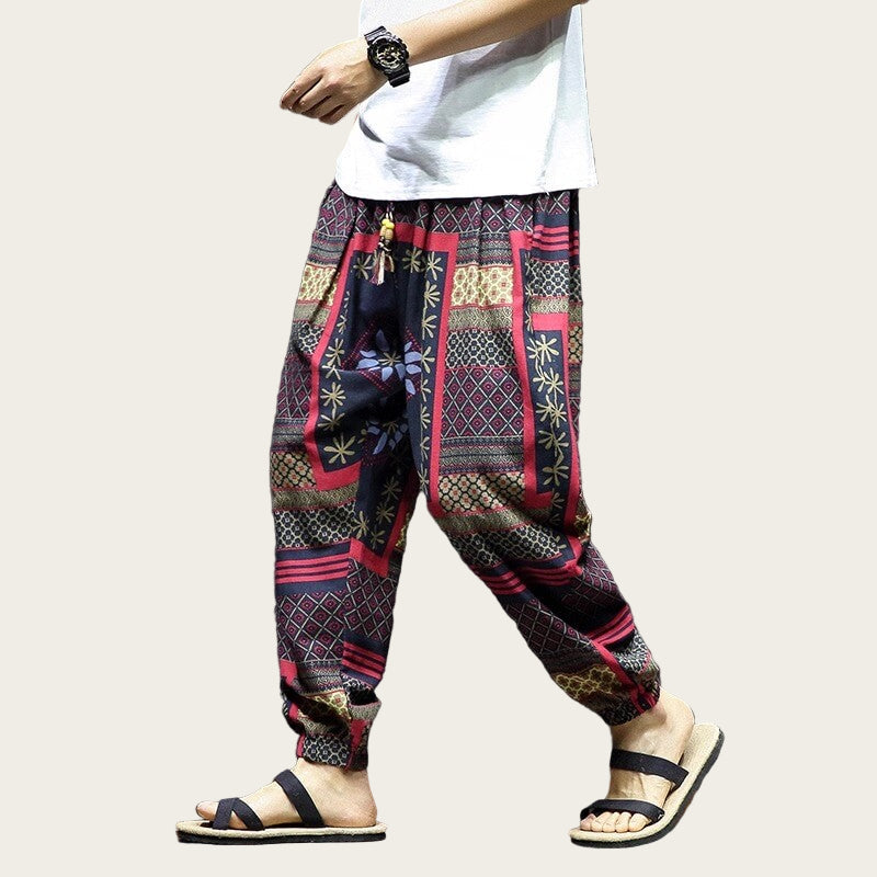 Person wearing patterned harem pants and sandals.