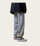 Person wearing gray sweatpants and black and white sneakers