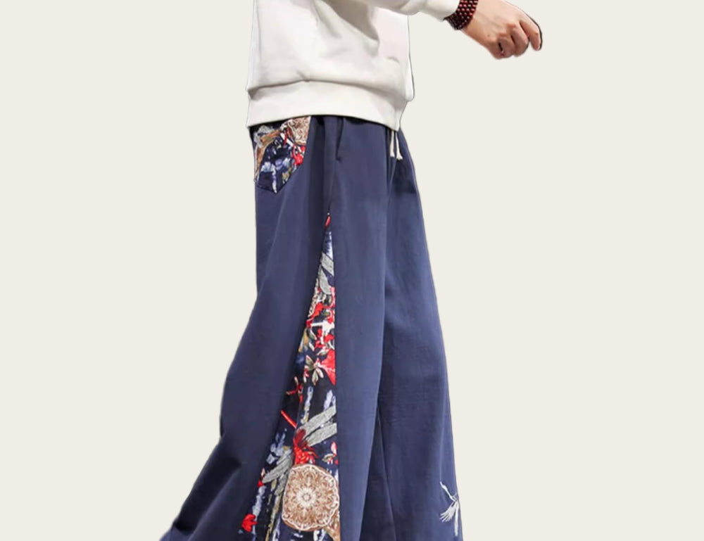 Navy blue pants with colorful patterns worn by a person in an indoor setting.