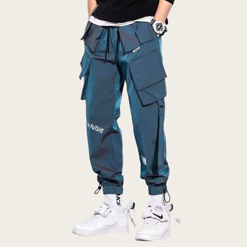 Person wearing blue cargo pants with multiple pockets on a yellow background