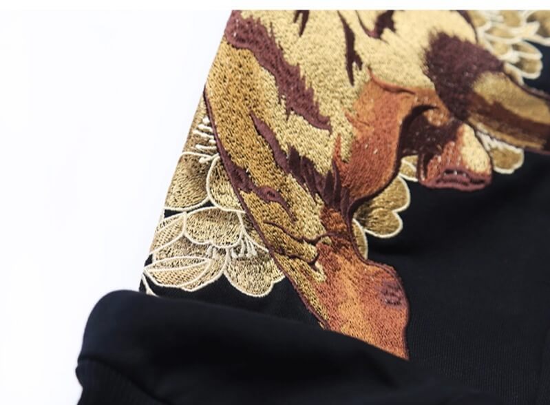 Close-up of a black garment with a floral and animal print design
