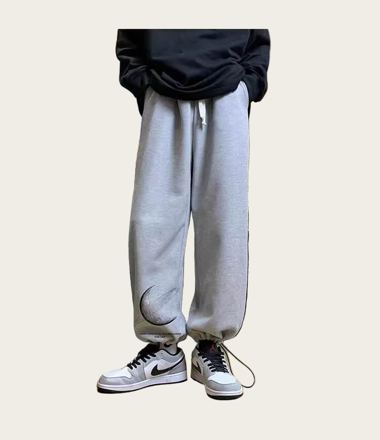 Person wearing gray sweatpants and white sneakers
