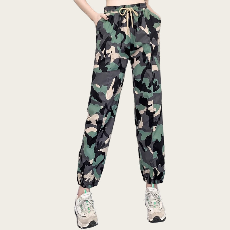 Camouflage pants worn by a person on a yellow background