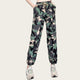 Camouflage pants worn by a person on a yellow background