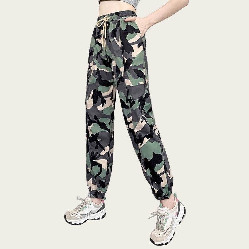 Camouflage pants worn by a person on a yellow background