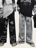 Two people wearing pants with butterfly and chain designs