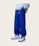 Person wearing blue pants and white sneakers