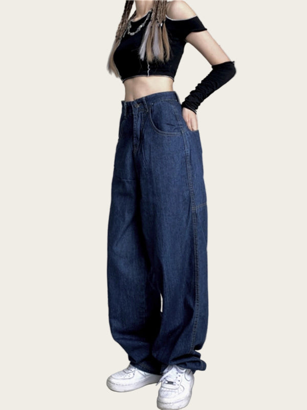 Person wearing a black crop top and blue jeans
