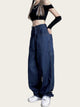 Person wearing a black crop top and blue jeans