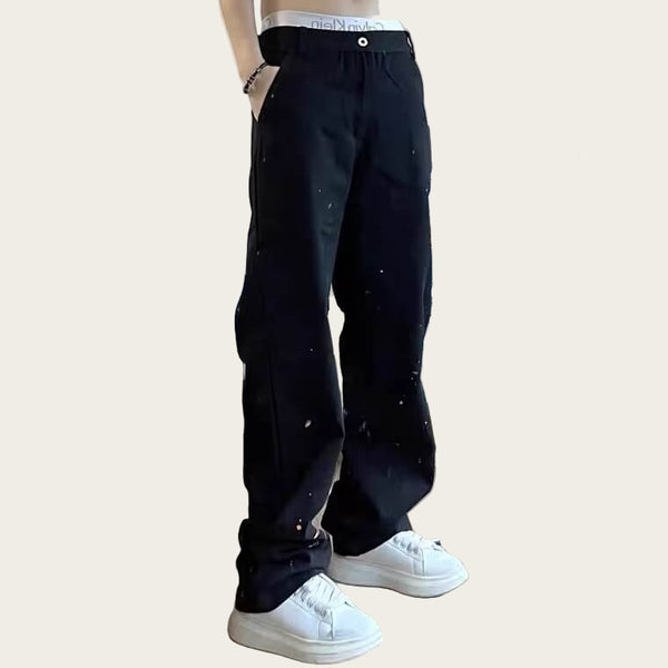 Person wearing black pants and white sneakers