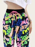 Colorful graphic pants with a white top on a white background