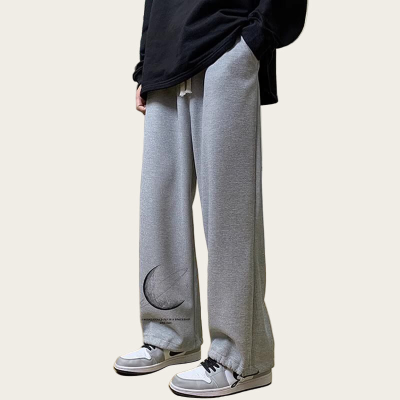 Person wearing gray sweatpants with a moon design