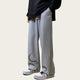 Person wearing gray sweatpants with a moon design