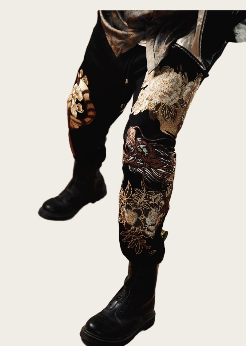 Black leather boots and pants with floral embroidery.