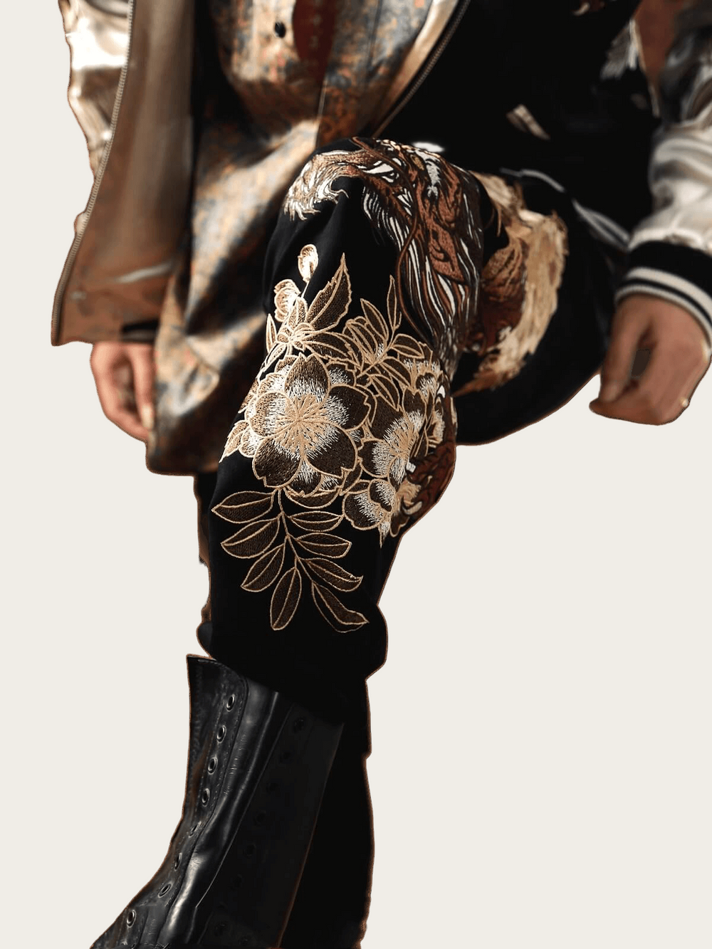 Close-up of a black boot with gold floral embroidery