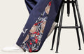 Navy blue pants with intricate patterns worn by a person, standing.