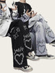 Two people wearing pants with decorative patterns