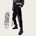 Person wearing black pants with white text and graphics, standing next to a skateboard with similar design elements.