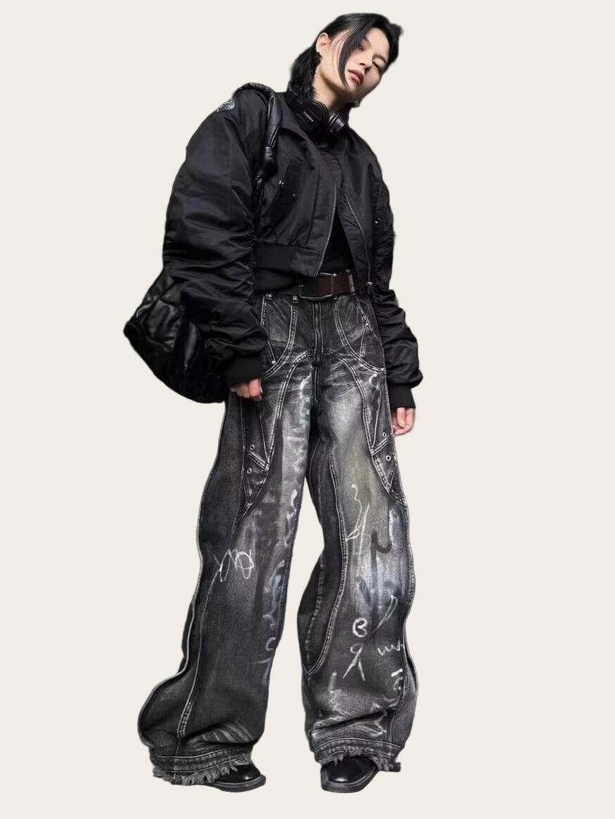 Person wearing a black jacket and gray pants