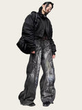 Person wearing a black jacket and gray pants