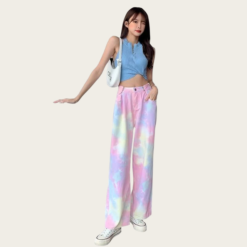 Woman wearing a blue sleeveless top and colorful tie-dye pants