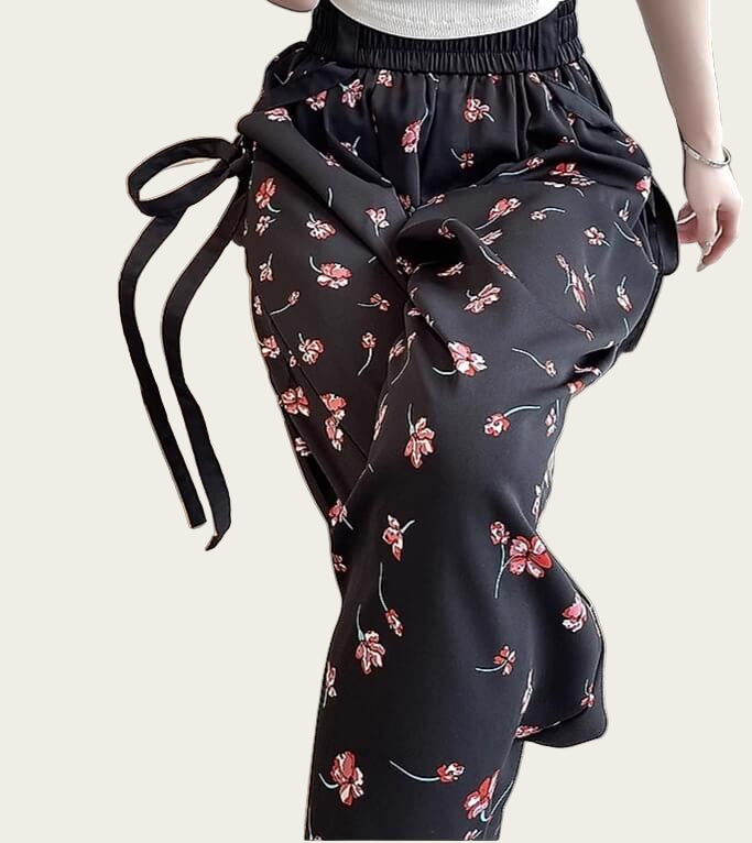 Black floral-patterned pants with a tie