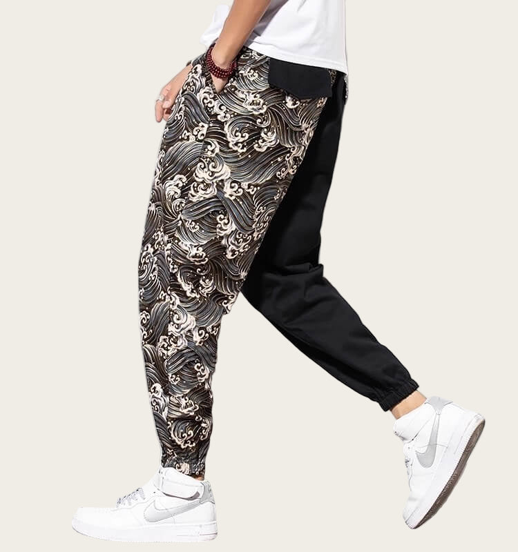 Person wearing a patterned harem pants with a yellow background