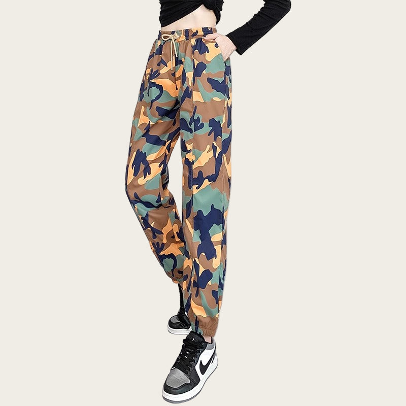 Camouflage pants worn by a person on a yellow background