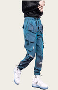 Blue cargo pants worn by a person on a yellow background