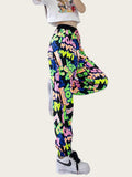 Person wearing colorful graphic pants and white sneakers