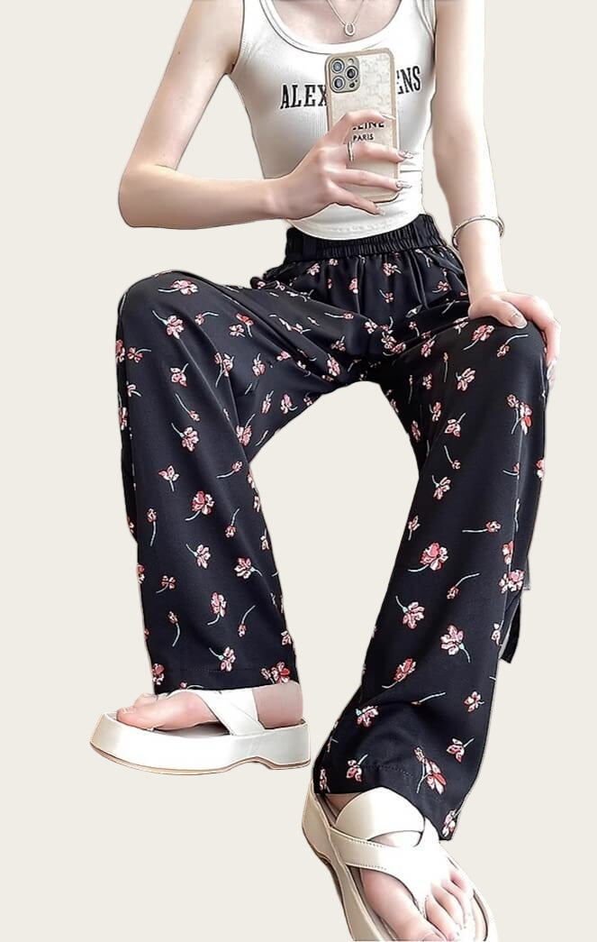 Person wearing floral pants and a white tank top