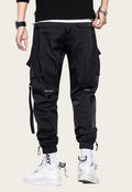 Black cargo pants worn by a person on a yellow background