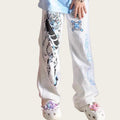 Person wearing white pants with colorful designs