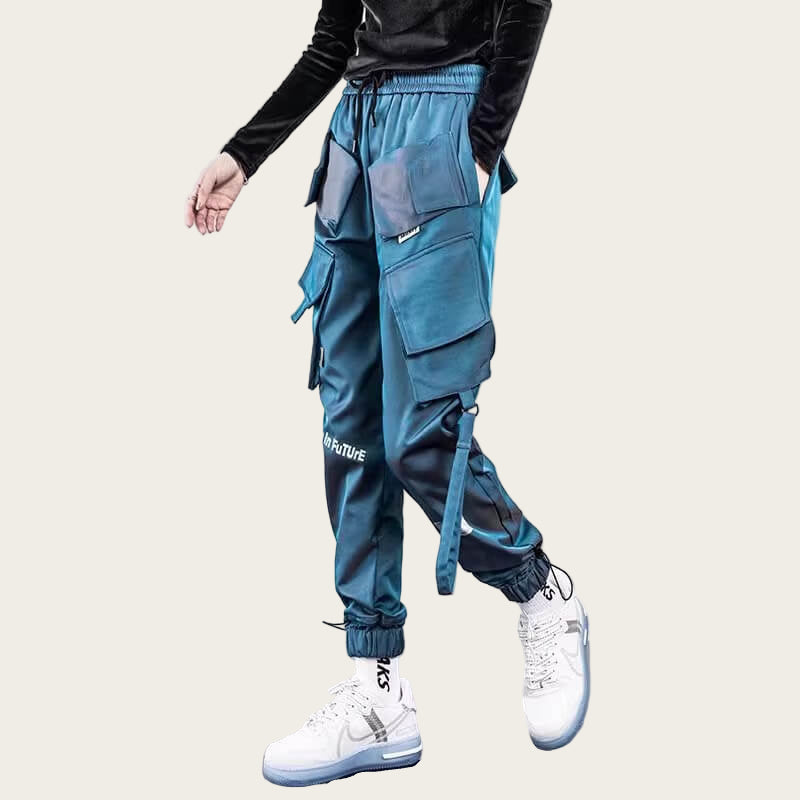 Person wearing blue cargo pants with multiple pockets on a yellow background