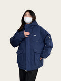Person wearing a blue jacket indoors
