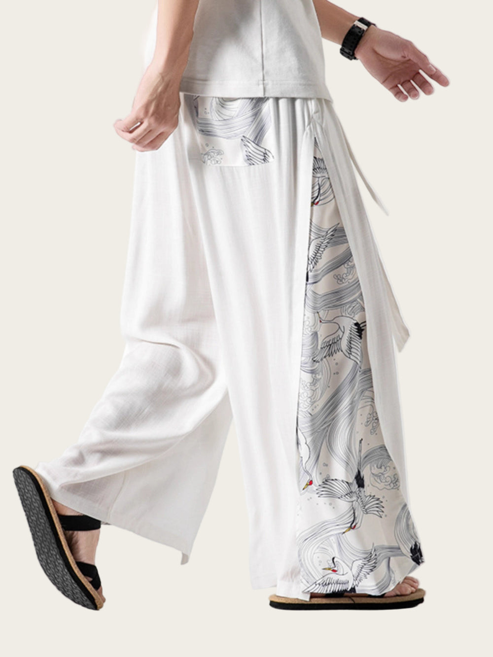 Person wearing white pants with a pattern, standing on a white background