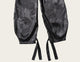 Black satin lingerie with intricate patterns on a white background