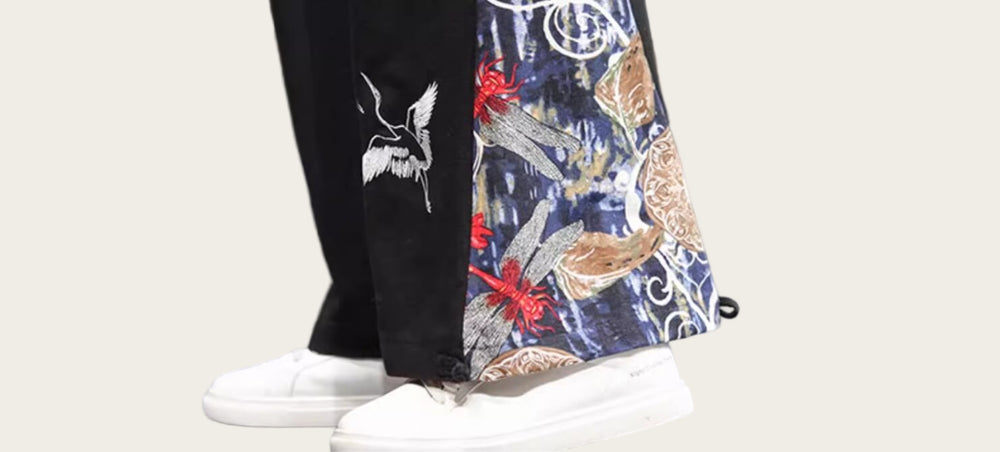 Colorful embroidered pants with white sneakers on a blurred background