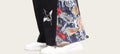 Colorful embroidered pants with white sneakers on a blurred background