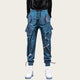 Blue cargo pants worn by a person on a yellow background