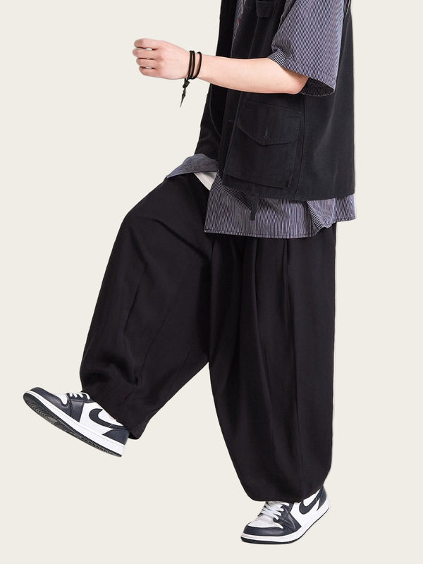 Person wearing a layered outfit with black pants and sneakers