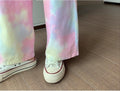 Tie-dye pants and white sneakers