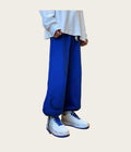 Person wearing blue pants and white sneakers