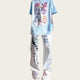 Light blue t-shirt with colorful graphics and white pants with black designs.