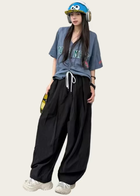 Person wearing a blue t-shirt and black pants