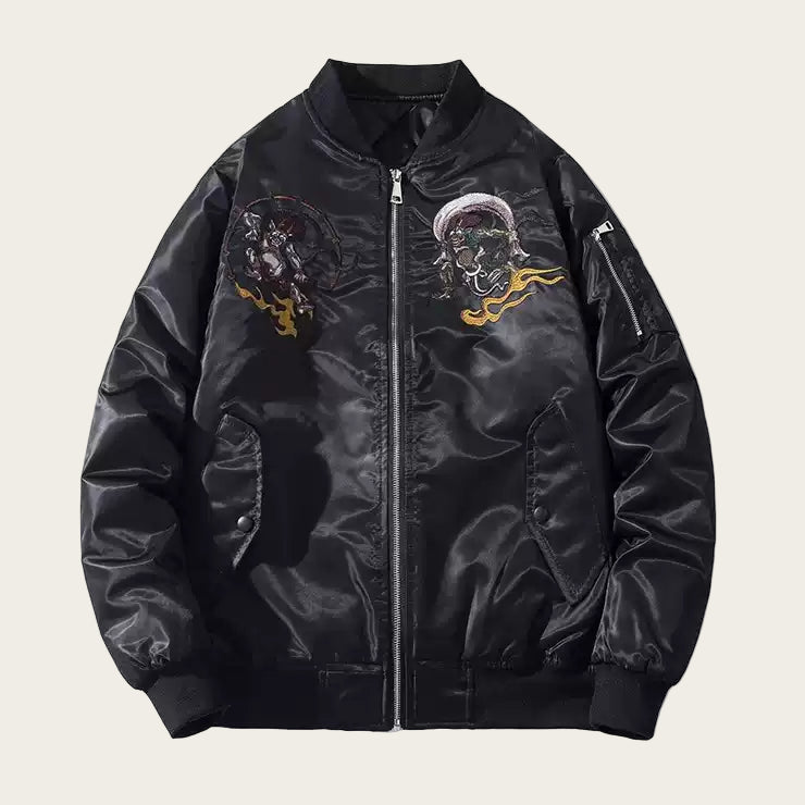 Black bomber jacket with embroidered designs on a white background