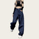 Person wearing a black crop top and blue jeans.