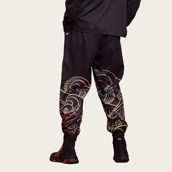 Person wearing black pants with gold patterns