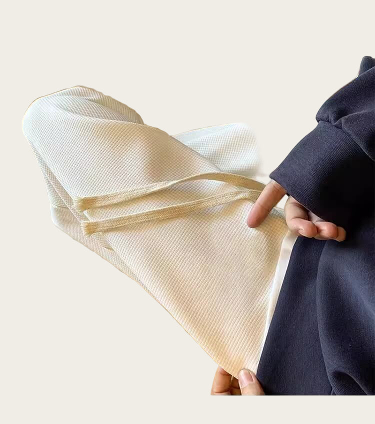 Person holding a piece of beige woven fabric